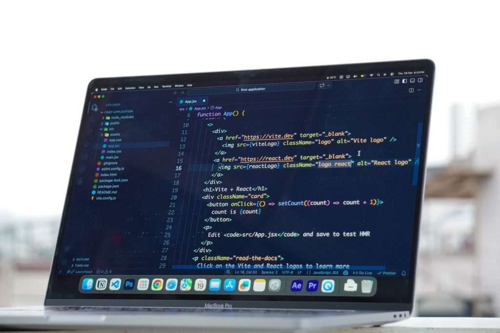 Coding on a laptop outdoors, showcasing a rooftop urban lifestyle in Surat, India.
