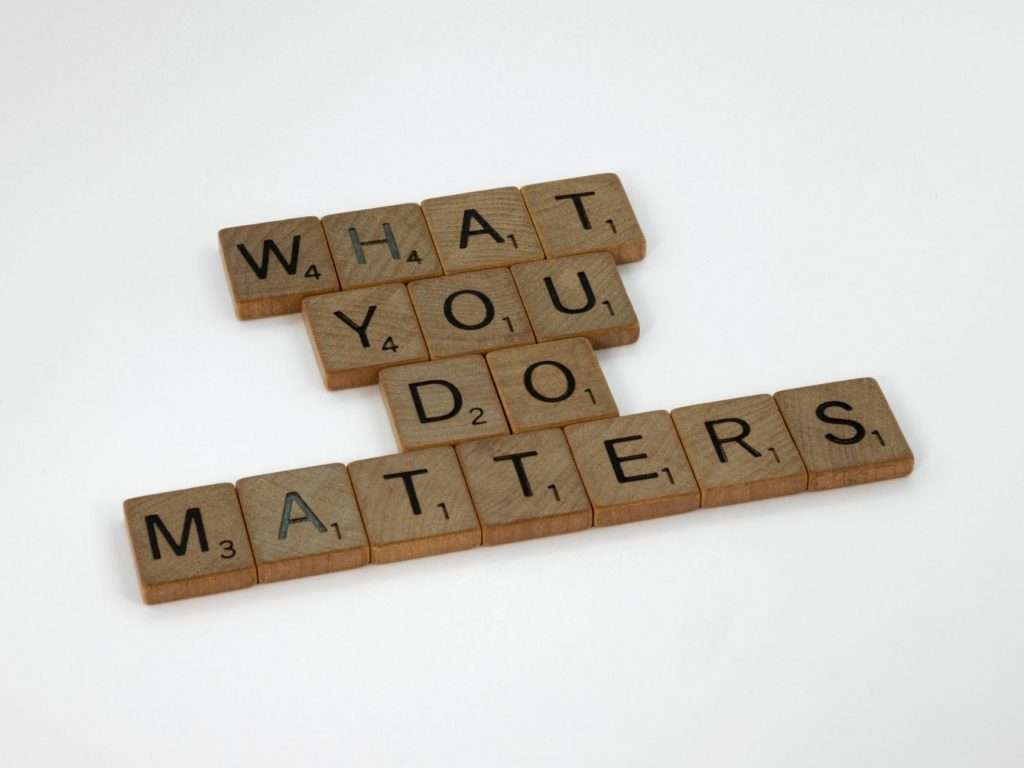 Wooden letter tiles spelling 'What You Do Matters' on a neutral background.