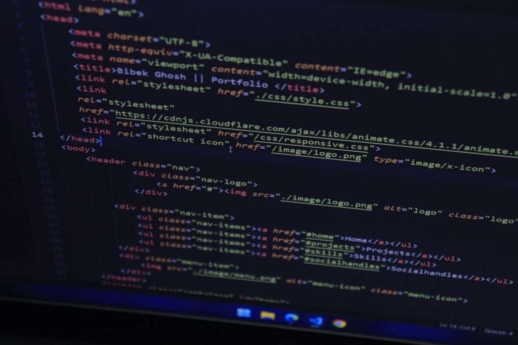 High-resolution close-up of HTML code displayed on a computer screen, perfect for technology themes.