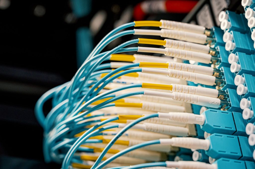 High angle of fiber optical switch with connected cables in modern server room