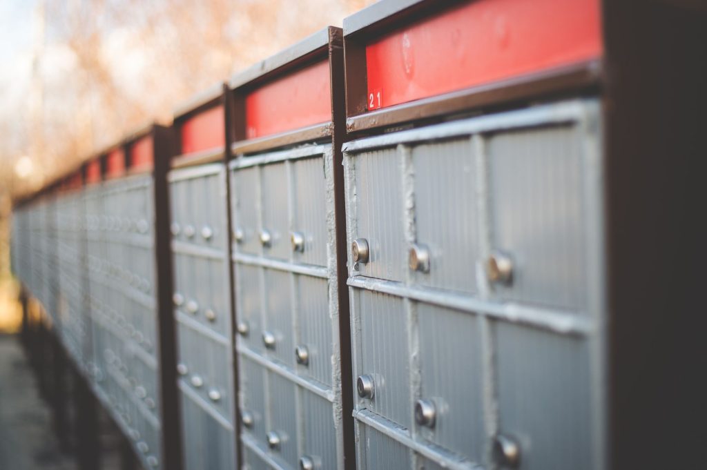 Vintage-style mailboxes in rows, showcasing safety and steel construction outdoors.